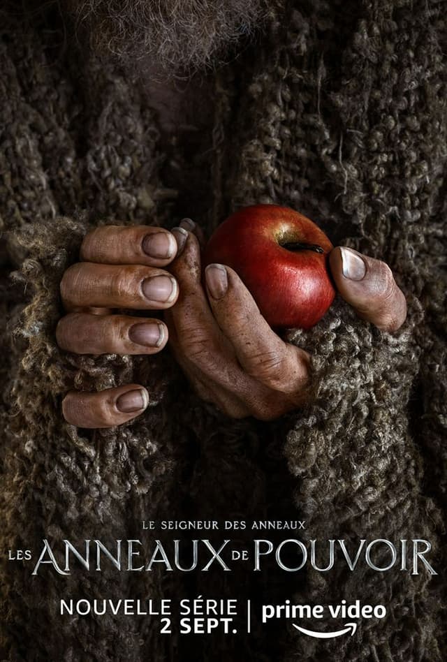 L'affiche promo qui montre les mains de l'Étranger, avec une pomme