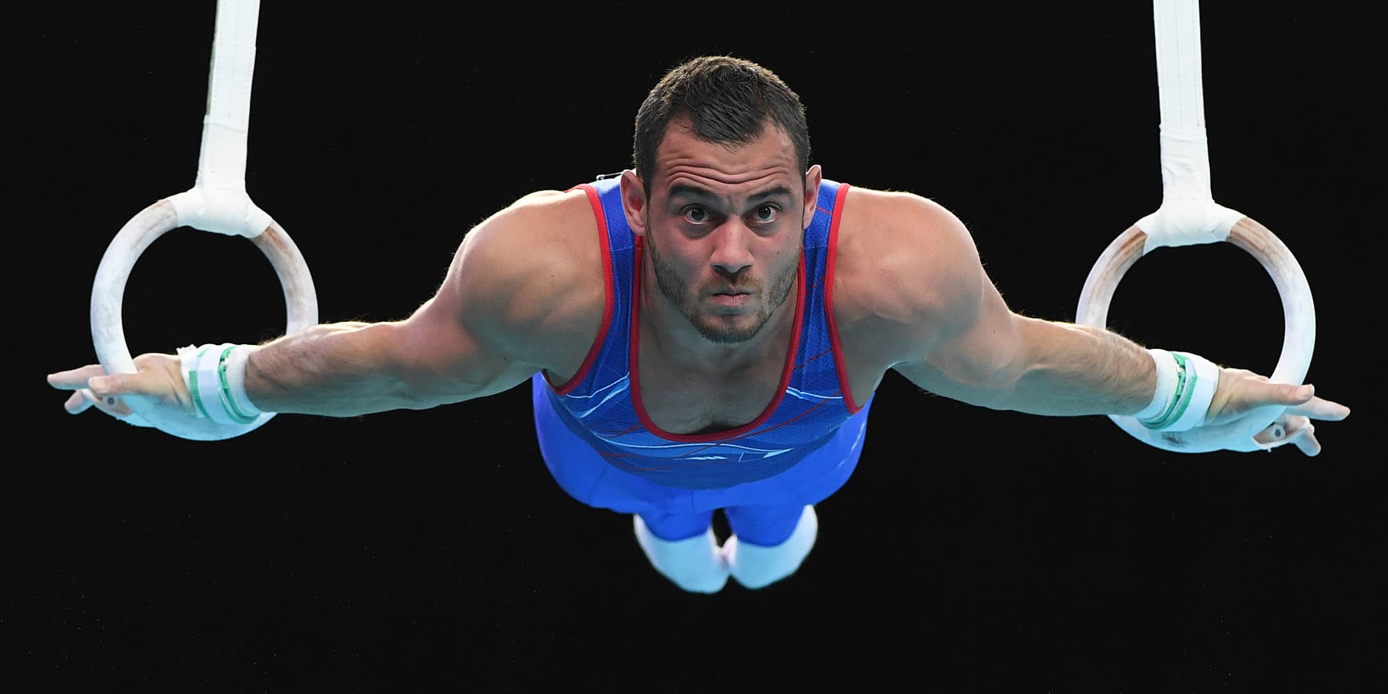 Samir Aït Saïd en pleine épreuve des anneaux lors des Championnats de gymnastique artistique de Szczecin, en Pologne, le 13 avril 2019.